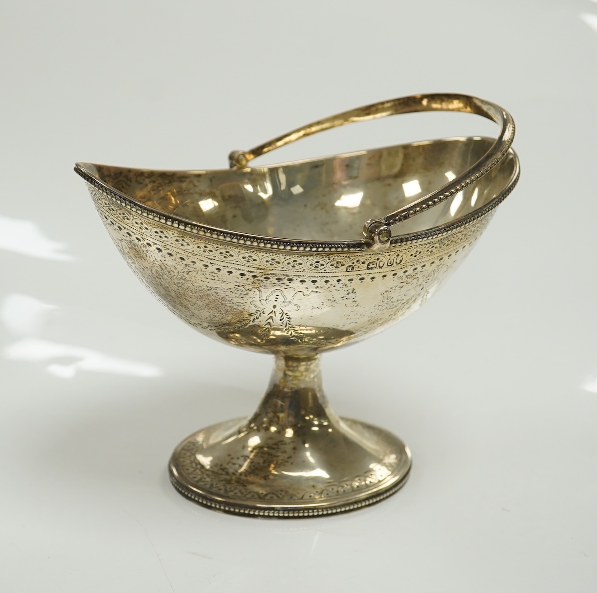 A Victorian engraved silver oval pedestal sugar basket, Henry Holland, London, 1869, width 15.5cm, 7.3oz. Condition - poor